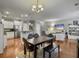 Open-concept layout with hardwood floors connecting the kitchen, dining, and living areas at 2064 Promenade Ct, Mount Pleasant, SC 29466