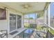 Comfortable screened-in back porch with seating and ceiling fan at 210 Delafield Dr, Summerville, SC 29483