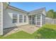 Home features a large concrete patio area, a screened in porch, and a large lawn at 210 Delafield Dr, Summerville, SC 29483
