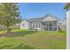 Home features a spacious backyard with green grass and an inviting screened-in porch at 210 Delafield Dr, Summerville, SC 29483