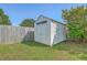 Backyard shed offers extra storage on a grassy lawn surrounded by a wood fence and lush greenery at 210 Delafield Dr, Summerville, SC 29483
