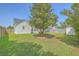 Home features a spacious backyard with green grass and an inviting screened-in porch at 210 Delafield Dr, Summerville, SC 29483