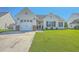 Charming home featuring a well-manicured lawn and attached garage at 210 Delafield Dr, Summerville, SC 29483