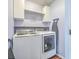 Well-equipped laundry room with modern washer and dryer units and organized storage at 210 Delafield Dr, Summerville, SC 29483