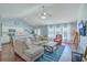 Inviting living room with plush sectional, ceiling fan, and natural light from large windows at 210 Delafield Dr, Summerville, SC 29483