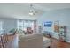 Cozy living room with vaulted ceilings, ceiling fan, and large windows with bright, natural light at 210 Delafield Dr, Summerville, SC 29483