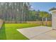 Grassy backyard featuring privacy fence, palm trees and view of the side of the home at 211 Saxony Loop, Summerville, SC 29486
