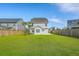 Expansive backyard with lush grass, secure fencing, and a view of the home at 211 Saxony Loop, Summerville, SC 29486
