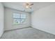 Well-lit bedroom featuring a window with blinds, ceiling fan, and gray carpet flooring at 211 Saxony Loop, Summerville, SC 29486