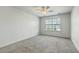 Bright bedroom with neutral walls and carpet features a window overlooking the neighborhood at 211 Saxony Loop, Summerville, SC 29486