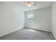 Well-lit bedroom featuring a window with blinds, ceiling fan, and gray carpet flooring at 211 Saxony Loop, Summerville, SC 29486