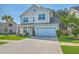 Charming two-story home with a well-maintained lawn, two-car garage, and a welcoming front entrance at 211 Saxony Loop, Summerville, SC 29486
