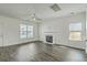 Bright, open living room with hardwood floors, a fireplace, and multiple windows at 211 Saxony Loop, Summerville, SC 29486