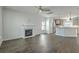 Open-concept living space with fireplace and hardwood floors leading into a modern kitchen at 211 Saxony Loop, Summerville, SC 29486