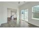 Open-concept living area with lots of sunlight, backyard access, and neutral walls at 211 Saxony Loop, Summerville, SC 29486