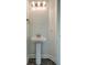 Simple powder room features a pedestal sink, modern lighting, and neutral paint at 211 Saxony Loop, Summerville, SC 29486