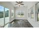 An airy sun room filled with natural light has sliding glass doors to the back yard at 211 Saxony Loop, Summerville, SC 29486