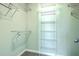 Walk-in closet with multiple wire shelves and gray carpet flooring at 211 Saxony Loop, Summerville, SC 29486
