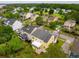 Aerial view of a yellow home in a beautiful residential neighborhood with water views at 2267 N Marsh Dr, Mount Pleasant, SC 29466