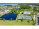 An aerial view of a community, showcasing a pond, tennis courts, and pool area at 2267 N Marsh Dr, Mount Pleasant, SC 29466