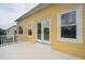 Back deck offers seamless indoor-outdoor living, highlighting a yellow exterior with double french doors at 2267 N Marsh Dr, Mount Pleasant, SC 29466