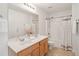Bright bathroom featuring double sinks, a neutral color palette, and a shower/tub combo at 2267 N Marsh Dr, Mount Pleasant, SC 29466