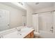 Bright bathroom featuring a tub and shower combination, large mirror, and a wooden vanity at 2267 N Marsh Dr, Mount Pleasant, SC 29466