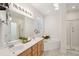 Bright bathroom featuring double sinks, tub, and a glass-enclosed shower at 2267 N Marsh Dr, Mount Pleasant, SC 29466