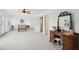 Large bedroom featuring a ceiling fan, plantation shutters, and vanity with stool at 2267 N Marsh Dr, Mount Pleasant, SC 29466
