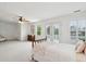 Spacious bedroom with a ceiling fan, white plantation shutters, and French doors to a balcony at 2267 N Marsh Dr, Mount Pleasant, SC 29466