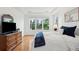 Cozy bedroom boasts wood floors and natural light from a large window at 2267 N Marsh Dr, Mount Pleasant, SC 29466