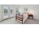 Bright bedroom featuring French doors leading to a balcony and charming decor at 2267 N Marsh Dr, Mount Pleasant, SC 29466