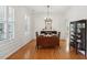 Elegant dining room with hardwood floors, chandelier lighting, and decorative wainscoting at 2267 N Marsh Dr, Mount Pleasant, SC 29466