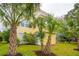 Charming yellow two-story home surrounded by lush landscaping and palm trees at 2267 N Marsh Dr, Mount Pleasant, SC 29466