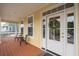 Inviting covered front porch with comfortable seating and a decorated front door at 2267 N Marsh Dr, Mount Pleasant, SC 29466