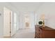 Bright hallway with neutral carpet, white walls, and views of a bathroom and a bedroom at 2267 N Marsh Dr, Mount Pleasant, SC 29466