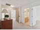 Hallway with neutral carpet, access to a bathroom, and a decorative wooden dresser at 2267 N Marsh Dr, Mount Pleasant, SC 29466