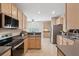 Spacious kitchen features stainless steel appliances, wood cabinets, and eat-in area filled with natural light at 2267 N Marsh Dr, Mount Pleasant, SC 29466