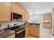 Updated kitchen boasts stainless appliances, light wood cabinetry and a modern cooktop with plenty of countertop space at 2267 N Marsh Dr, Mount Pleasant, SC 29466