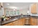 Eat-in kitchen features updated stainless steel appliances, wood cabinets, breakfast bar, and modern faucet at 2267 N Marsh Dr, Mount Pleasant, SC 29466