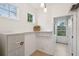Bright laundry room with storage shelf and natural lighting at 2267 N Marsh Dr, Mount Pleasant, SC 29466