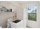 Laundry area with washer, dryer, shelves, and a window at 2267 N Marsh Dr, Mount Pleasant, SC 29466