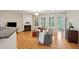 Open-concept living area with hardwood floors, fireplace, natural light, and seamless flow to kitchen and outdoors at 2267 N Marsh Dr, Mount Pleasant, SC 29466
