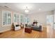 Cozy living room with natural light and wood floors offers comfortable seating at 2267 N Marsh Dr, Mount Pleasant, SC 29466