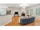Bright living room with hardwood floors, fireplace, and abundant natural light from large windows at 2267 N Marsh Dr, Mount Pleasant, SC 29466