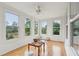 Light-filled sunroom with many windows and an outdoor view to the backyard at 2267 N Marsh Dr, Mount Pleasant, SC 29466