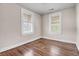Bedroom featuring wood floors and natural light from two windows at 2373 Sorentrue Ave, North Charleston, SC 29405