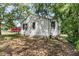 The side of the home featuring wood siding, multiple windows, and a partial brick foundation at 2373 Sorentrue Ave, North Charleston, SC 29405