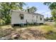 Rear view of the home featuring wood siding, multiple windows, and a set of stairs to the back door at 2373 Sorentrue Ave, North Charleston, SC 29405