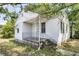 Modest home featuring wood siding, front porch with a metal railing, and a brick foundation at 2373 Sorentrue Ave, North Charleston, SC 29405